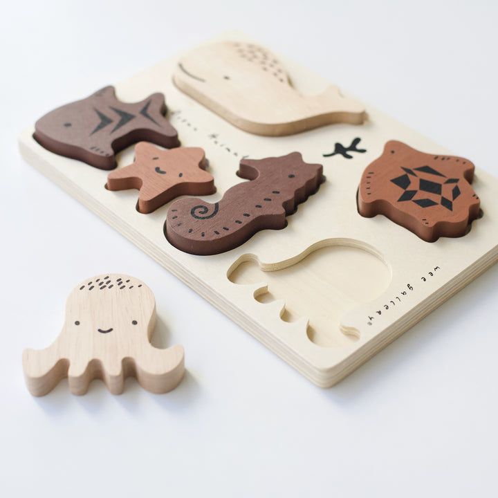 Ocean Animals Wooden tray puzzle with octopus, whale, turtle, fish, starfish, and seahorse shaped pieces.