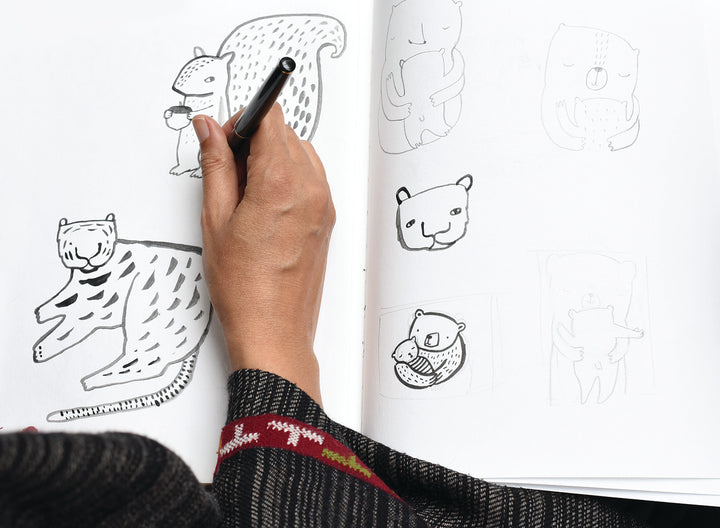 Wee Gallery creator Surya drawing animals in her sketchbook.