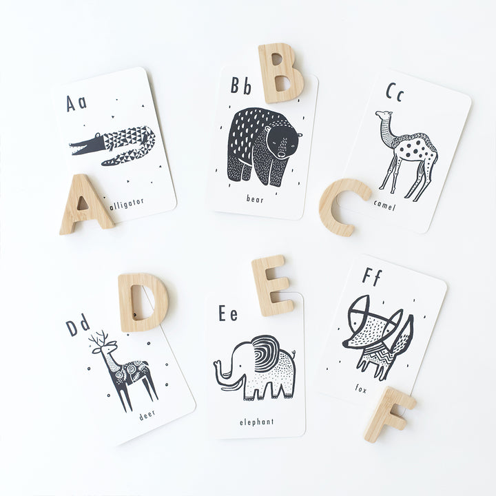 Wooden alphabet letters a through f paired with corresponding animal alphabet cards.