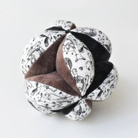 black, white and brown soft clutch ball with woodland animal pattern